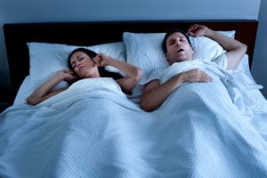 Man with his wife havingSleep Apnea