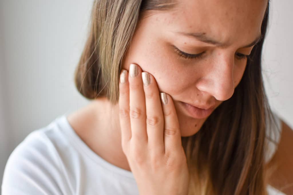 A woman experiencing jaw pain
