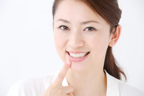 face of beautiful woman showing her teeth